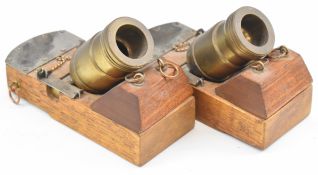 A pair of desk or signalling bronze mortar cannon each raised on wooden carriage, 16.5cm long.