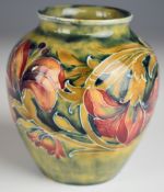 William Moorcroft vase decorated in the Spanish pattern on an early pale green ground, with early W.