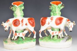 Pair of 19thC Staffordshire figural cow and suckling calf spill vases H30cm
