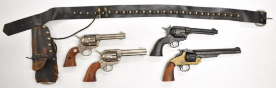 Four Colt and Remington style replica revolvers including BKA and SMG, one in leather holster and