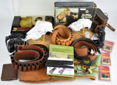 A collection of gun and shooting related items including canvas and leather gun slip, cartridge