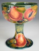 William Moorcroft chalice decorated in an early Pomegranate pattern on pale green ground with