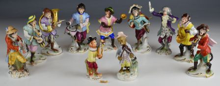 Eleven Dresden, Sitzendorf and other porcelain monkey band figures, tallest 16cm