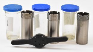 Three Beretta shotgun chokes and choke key.