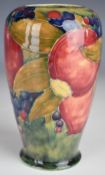 William Moorcroft vase decorated in the early Pomegranate pattern on pale green ground with open
