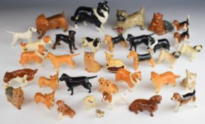 Approximately thirty six Beswick and Royal Doulton dog figures including Norfolk Terrier, Collie,