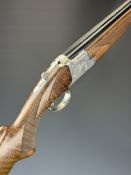 Browning B2G 12 bore over and under ejector shotgun with engraved scenes of birds to the locks,
