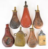 Seven various powder flasks including three with embossed decoration of arms and insignia, 'John