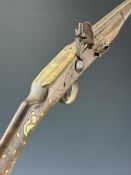 Eastern flintlock gun with bone inlaid decoration to the stock, metal barrel bands and ram-rod and