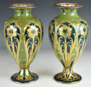 Matched pair of William Moorcroft Macintyre Florian Ware green and gold vases, signed and with
