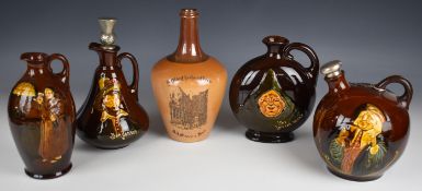 Four Royal Doulton Kingsware whisky decanters, one with hallmarked silver stopper and an advertising