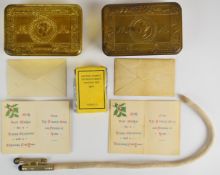 Two Princess Mary 1914 Christmas tins, one containing a packet of tobacco, the other a lighter, both