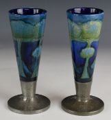 Matched / very close pair of William Moorcroft floral vases decorated in the Moonlit Blue pattern,
