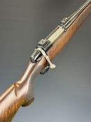 English .303 bolt-action rifle with chequered semi-pistol grip and forend, raised cheek piece, scope