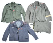 Three reproduction German military uniforms, one with Konrad Tiede & Co, Hannover stamp