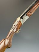 SKB 500 12 bore over and under ejector shotgun with engraved scenes of birds to the locks,