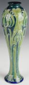 William Moorcroft Macintyre Florian Ware slender vase decorated with tulips on a tapering pale green