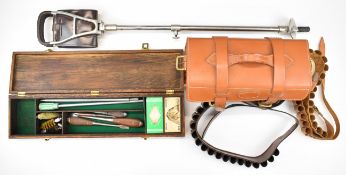 A collection of gun and shooting related items including leather cartridge bag, cartridge belts,