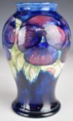 William Moorcroft baluster vase decorated in the Pansy pattern, signed and with impressed marks to