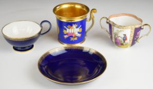 Sèvres cup and saucer with cobalt blue glaze, a tankard with armorial gilt decoration and gilt