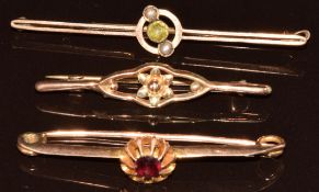 Three 9ct gold brooches, one set with a peridot and seed pearls, 5.6g