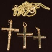 Two 9ct gold cross pendants and a 9ct gold crucifix, with damaged chain, 4g