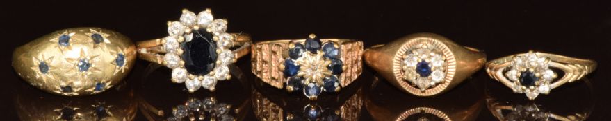 Three 9ct gold rings set with sapphires and cubic zirconia, a 9ct gold ring set with sapphries in