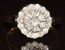 A 9k ring set with round cut diamonds in a cluster, the total approximately 0.65ct, 4.4g, size O