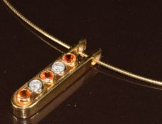 Catherine Best 18ct gold pendant set with three round cut mandarin garnets and two round cut