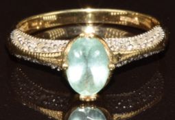 A 9k gold ring set with an oval cut Brazilian Paraiba tourmalines of approximately 0.5ct and white