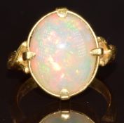 An 18ct gold ring set with an oval opal cabochon, 7.7g, size N