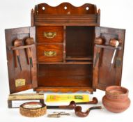 19th or early 20th century oak smoker's cabinet or cupboard, with carved decoration to the doors,
