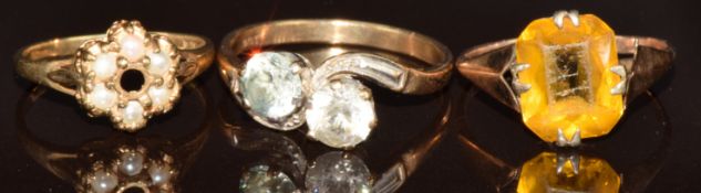 Three 9ct gold rings, one set with zircons, one with paste and another with pearls (missing centre