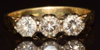 An 18ct gold ring set with three diamonds, the total approximately 0.9ct, 4.6g, size Q