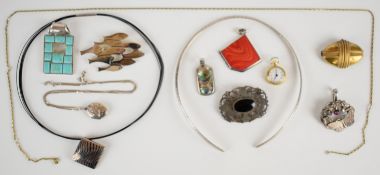A collection of silver jewellery including three pendants, a locket, brooch, hammered torque