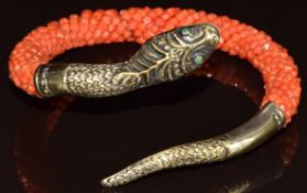 A c1900 French silver gilt serpent bangle set with green paste eyes and beaded coral body, 23.8g