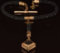 Victorian gold plated locket set with carved jet cameo, on a beaded French jet fob chain