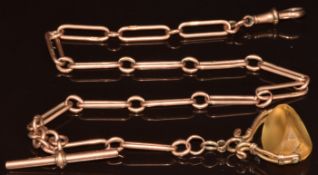 A 9ct rose gold Albert / watch chain made up of elongated and oval links, with glass swivel fob,