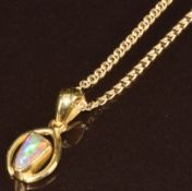 An 18k gold pendant set with a black opal doublet, on 18k gold chain, 4.4g, 50cm