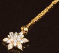 A 9k gold pendant set with nineteen round cut diamonds, total 0.25ct, on 9ct gold chain, with
