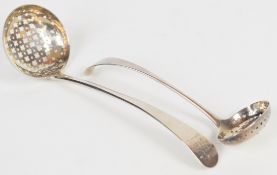 Two Georgian hallmarked silver sifter ladles, the larger with maker's mark and one other mark