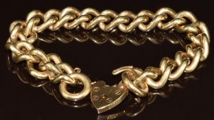 A 9ct gold curb link bracelet with heart padlock clasp, 63g, 20cm