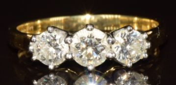 An 18ct gold ring set with three round cut diamonds of approximately 0.38, 0.25 & 0.25ct, 3.3g, size