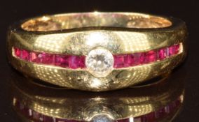 A 14k gold ring set with calibre cut rubies and a round cut diamond, 4.1g, size L