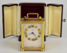 Looping of Switzerland miniature carriage clock with brass case, raised on four turned feet,