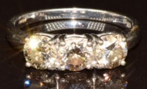 An 18k white gold ring set with three round brilliant cut Argyle champagne diamonds, total carat