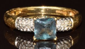 An 18k gold ring set with a square cut Alexandrite of approximately 1ct and diamonds, with