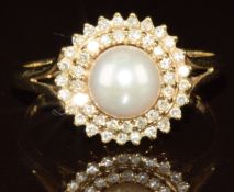A 9ct gold ring set with a pearl and two circles of diamonds, 2.9g, size P