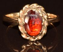A yellow metal ring set with a garnet, 3.3g, size K/L