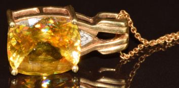 An 18k gold pendant set with an antique cut sphene of approximately 9ct and a diamond, on 18k gold